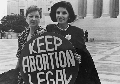 Jane Roe and Gloria Allred hold a sign that says, "Keep Abortion Legal"